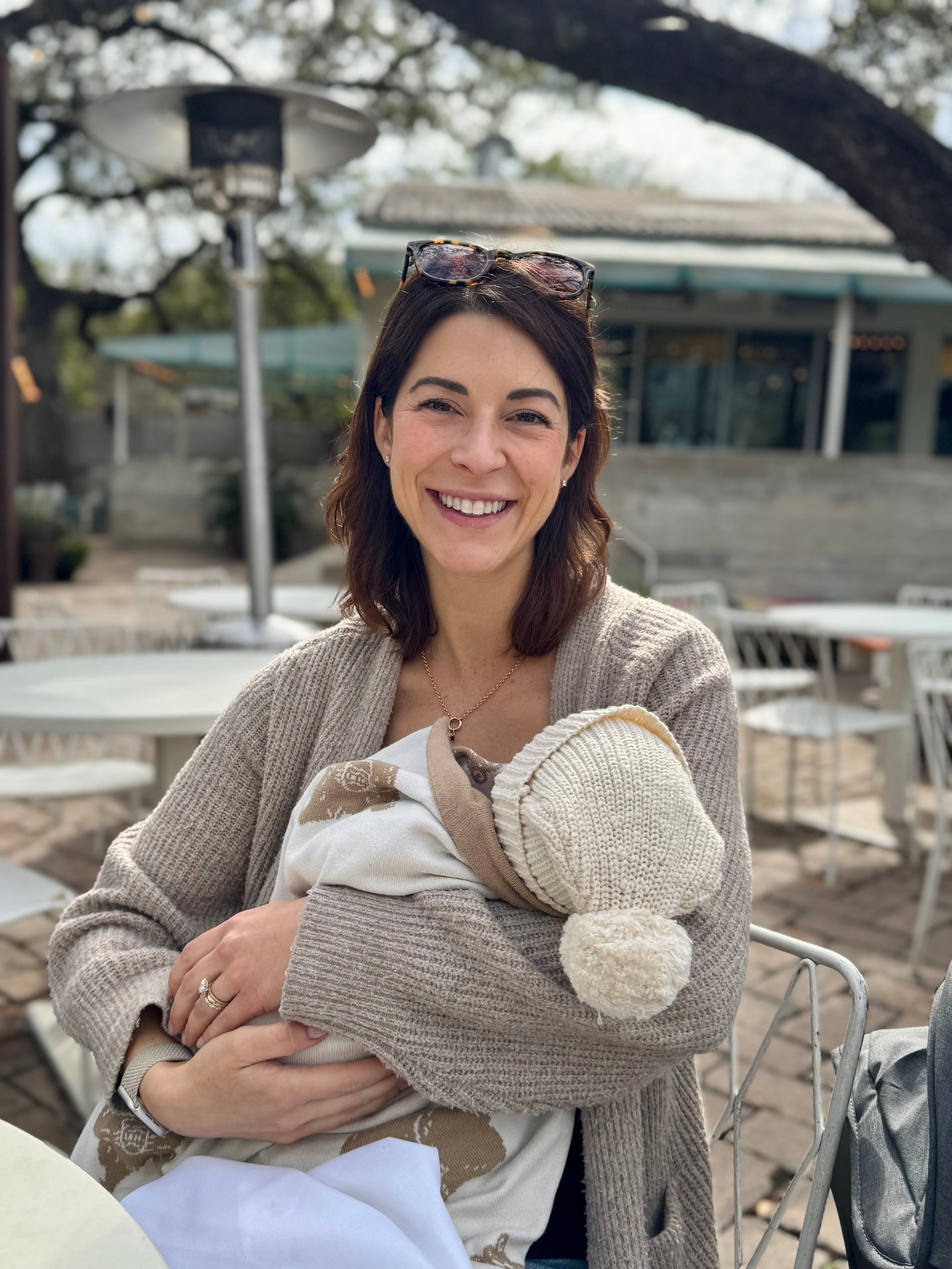 Emily, founder of Noshwell, holding her newborn son